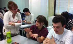 Prof. Gena Greher consults with music major Maria Price and computer science major Chris Adoretti on their project.