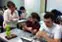 Prof. Gena Greher consults with music major Maria Price and computer science major Chris Adoretti on their project.
