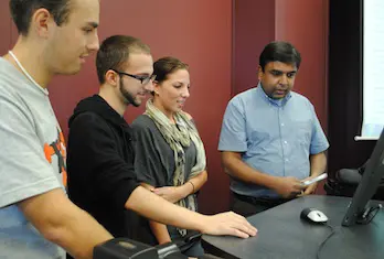 From left, students Michael Kilbride, Wallas Vieira, Angela Pasquarello and Associate Prof. Ravi Jain will meet with Warren Buffett on Nov. 11.