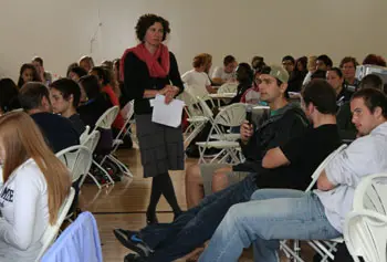 Assoc. Prof. Juliette Rooney-Varga, standing, moderates the discussion at the Climate Change Teach-in.
