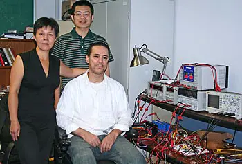 
						Assoc. Prof. Tingshu Hu with her graduate students Haifeng Wang, center, and Khalid Kanane.
					