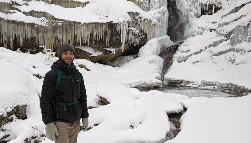 Vincent Ciaramella standing in front of a frozen waterfall