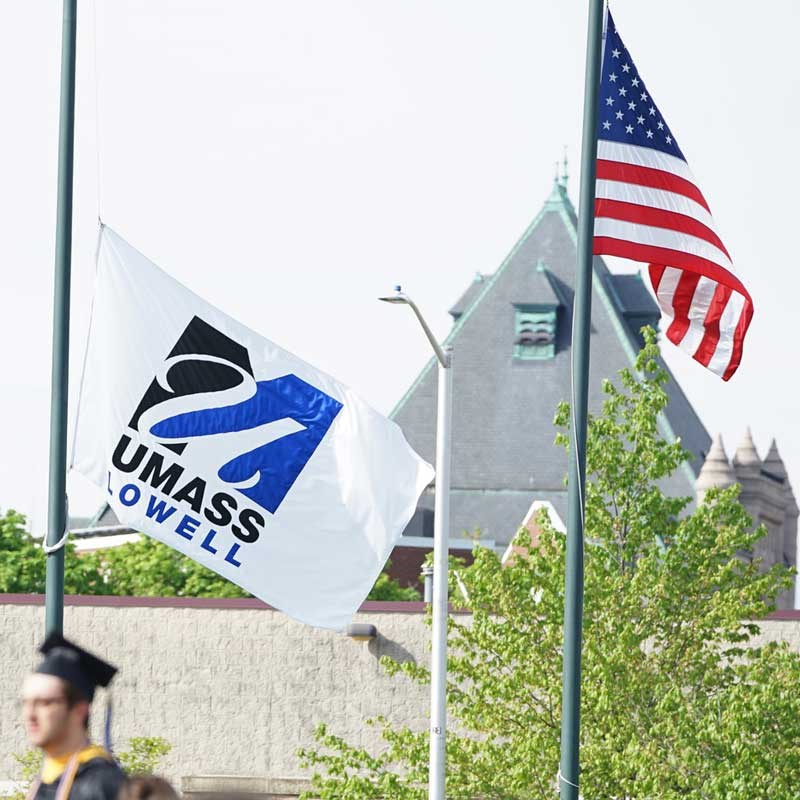 A Umass Lowell flag and United States of America flag