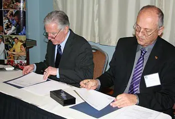 UMass Lowell Chancellor Marty Meehan, left, and Zvi HaCohen, rector of Ben-Gurion University of the Negev in Israel, exchange gifts before signing a memorandum of understanding to establish a partnership between the two schools.