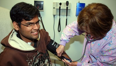 A male student gets his blood pressure checked at Student Health Services.