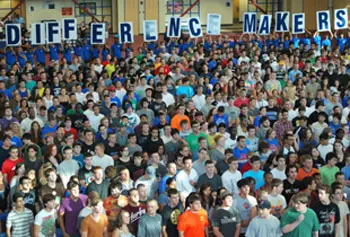 Students involved in the DifferenceMaker program held up signs during Convocation in September.