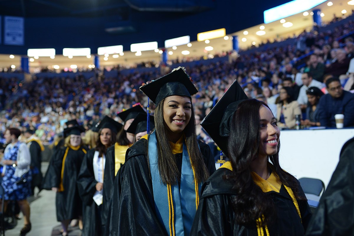 A female graduate smiles during morning Commencement on May 19, 2018.