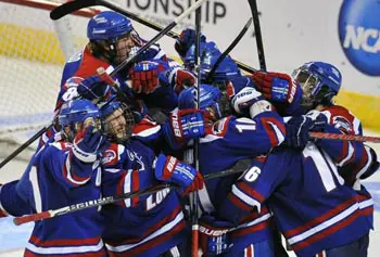 Somewhere in this happy River Hawk scrum is Riley Wetmore, who scored at 2:13 of overtime. (Jessica Hill/Associated Press)