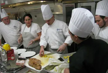 Anna Jabar-Omoyeni, owner and chef at La Boniche restaurant in downtown Lowell, works with Dining Services staff to prepare a menu for the campus dining halls as part of the Visiting Chef series.