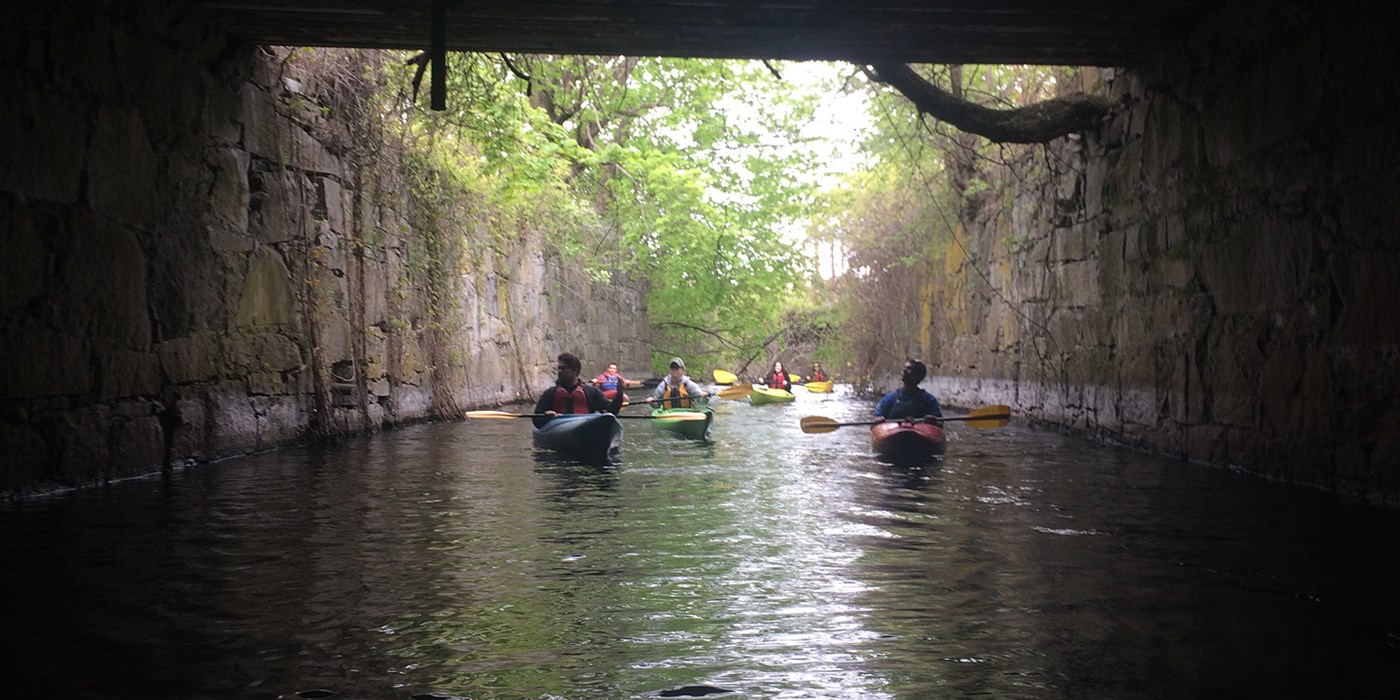 Group of Kayakers Explore a Tunnel. At the UMass Lowell Kayak Center you can rent kayaks, canoes, stand-up paddle boards or sign up for kayaking instructional programs, tours and events! 