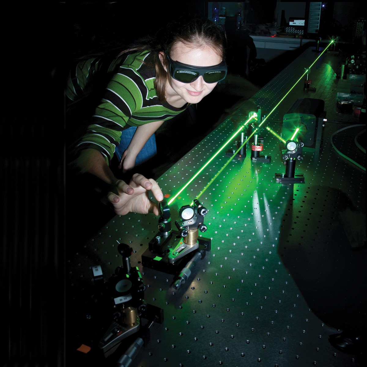 female student in lab working with lasers