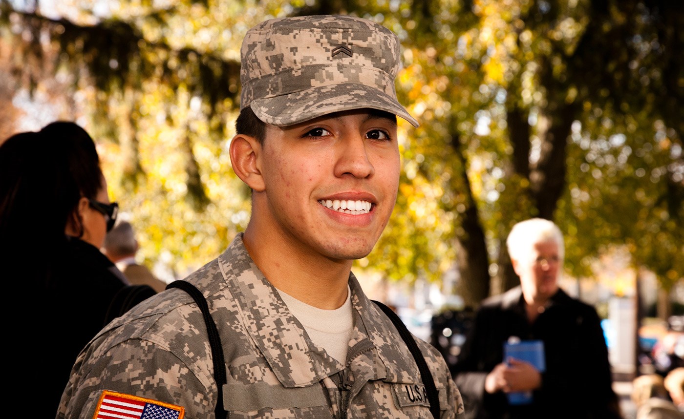 A UMass Lowell Army ROTC cadet smiles at a flag raising ceremony on Veterans Day.