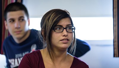 A female UMass Lowell Manning School of Business students looks on during a class.
