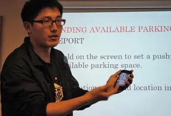 Peng Xia explains the &ldquo;UML Parking Finder&rdquo; smartphone app he developed in collaboration with fellow student Shan Lu.