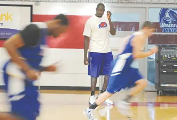 UMass Lowell assistant basketball coach Souleymane Wane, who played for national champion UConn in 1999, watches players go through their paces at a River Hawk practice this week.