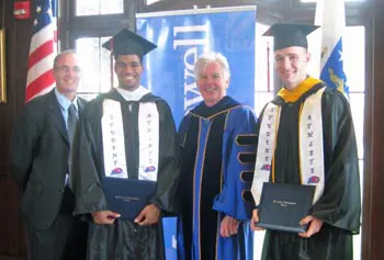 From left, head coach Gary Gardner, senior Donte Brown, Chancellor Marty Meehan, senior Angus MacDonald.