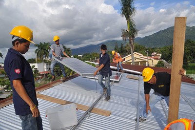 Students helping install a solar PV system on the roof of school for at-risk youth.