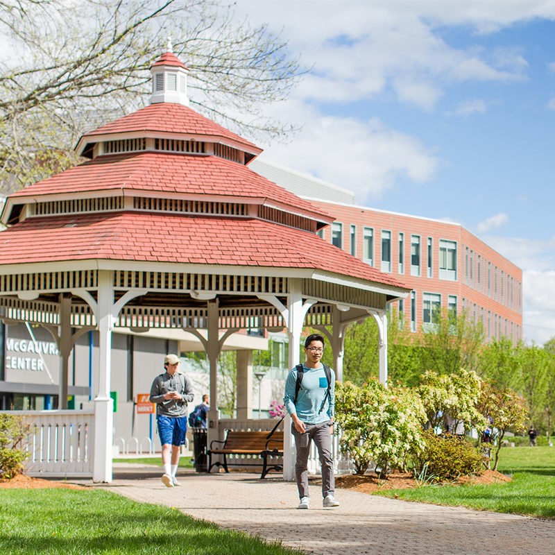Spring time image of south campus gazebo with students walking by.