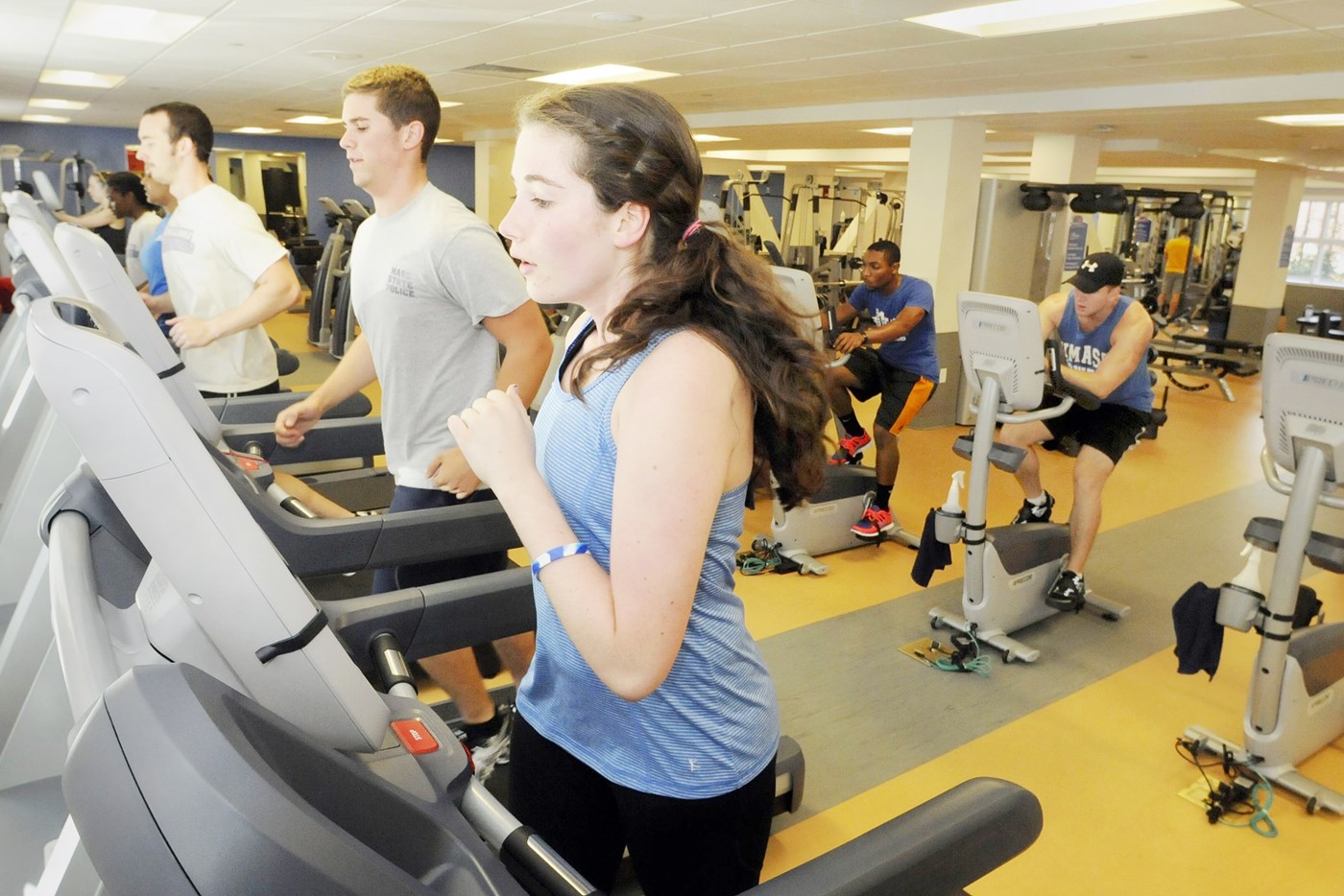 Students running on treadmill inside Riverview Suites Fitness Center.