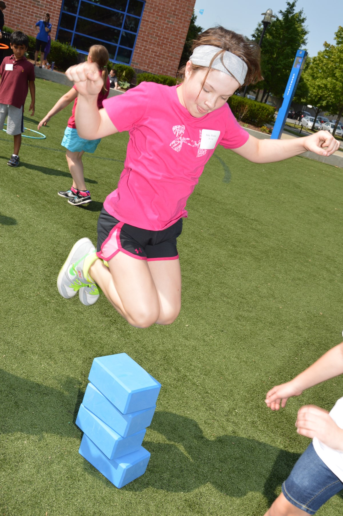 Girl jumps over yoga blocks