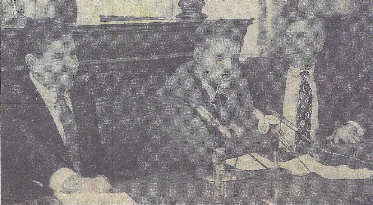 Roger Lang, Michael Gallagher, and Brian Martin sitting at a desk with microphones.