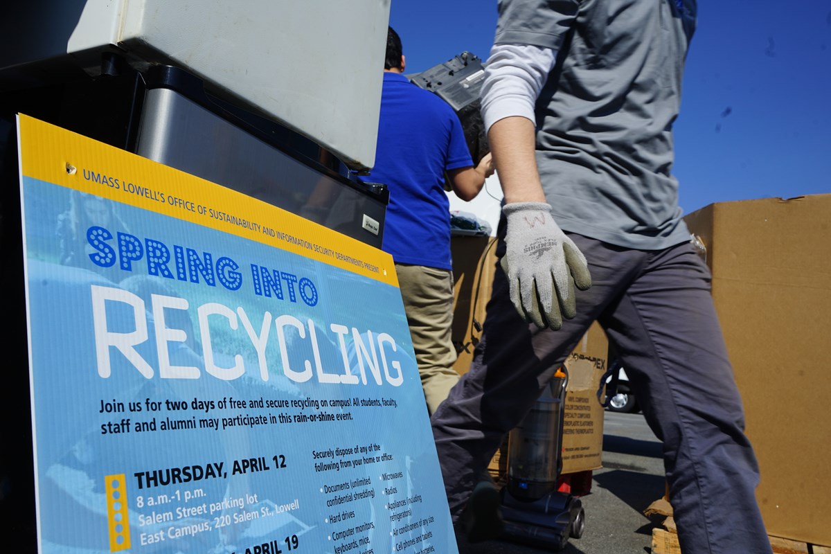 Spring Into Recycling Event: Workers Moving, Sign in Foreground