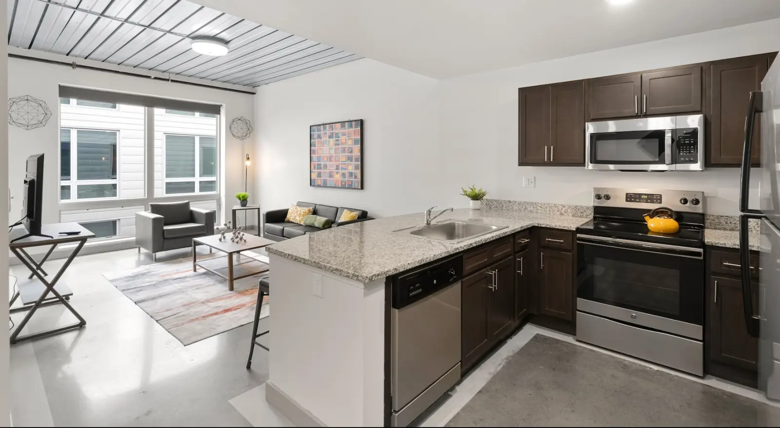 Kitchen and living room inside 1 Merrimack Plaza at UMass Lowell.
