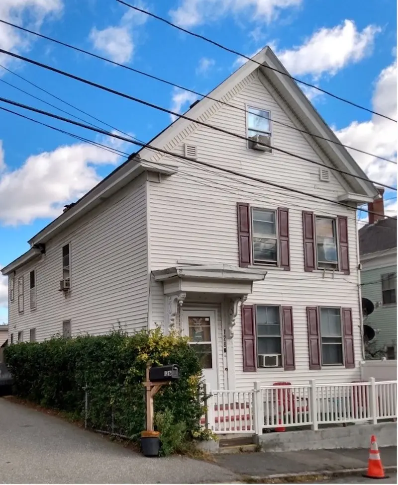 Vinyl sided two-story home in Greek Revival style.