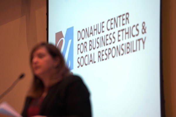 Business dean Sandra Richtermeyer speaks in front of Donahue Center logo