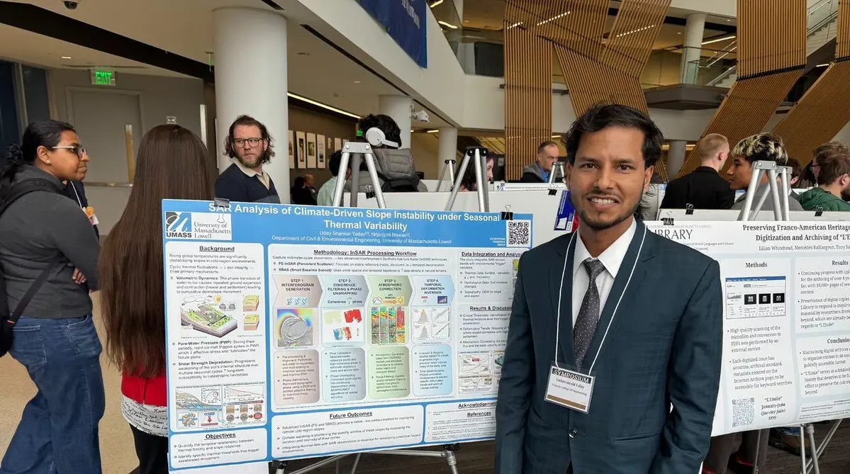 Yaduwanshi Uday standing beside his poster and presentation on satellite-based remote sensing for geotechnical hazard assessment.