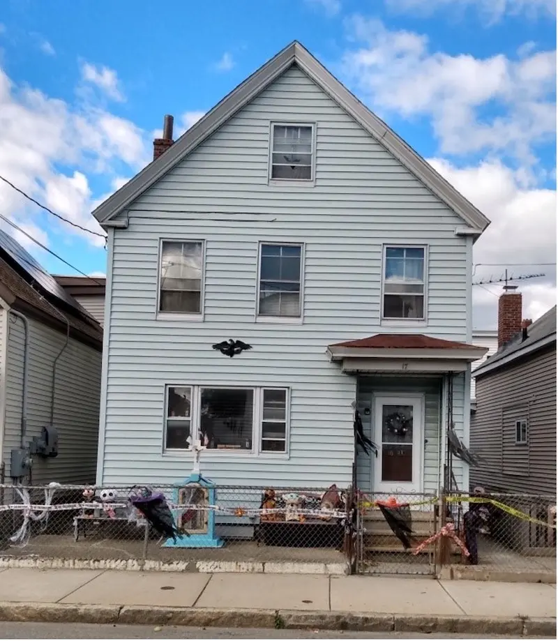 Exterior of two-story home with side entrance. 