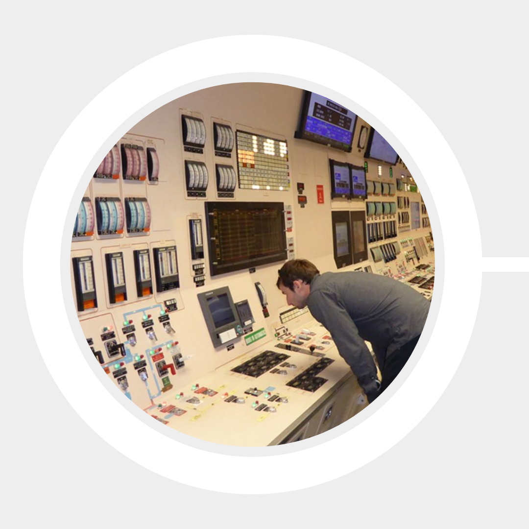 A technician examines the controls at the Radiation Facility.