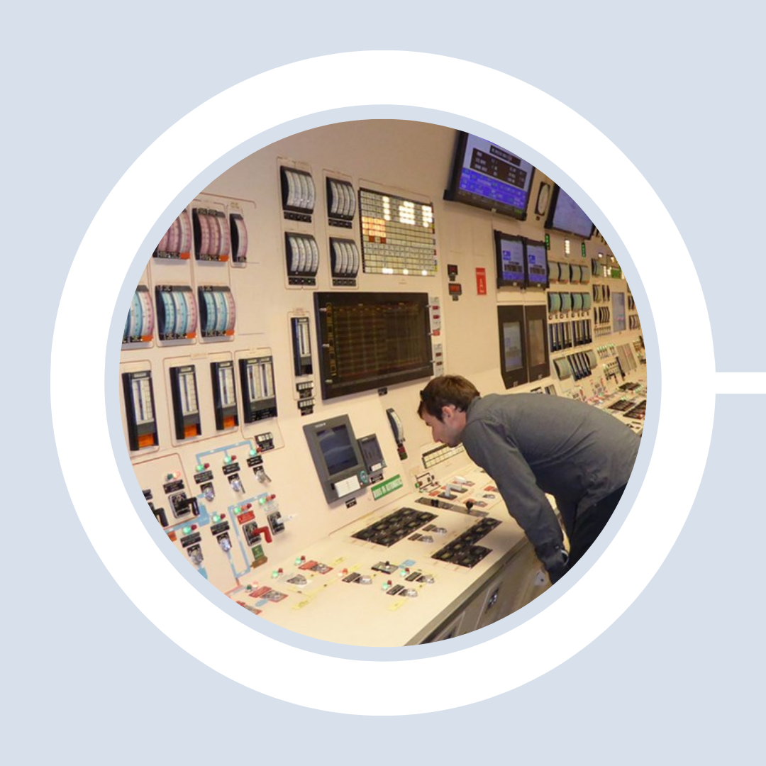 A technician examines the controls at the Radiation Facility.