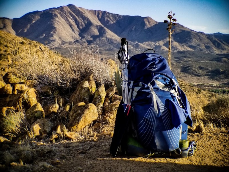 Kyle Soeltz's hiking pack against a backdrop of mountains on the Pacific Crest Trail