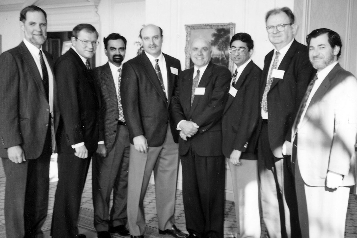 Dr. (Chancellor) Hogan, Husain Wetherell, Dr. Domas, Dr. Williamson, McGuirl, Provost Sukant Tripathy and Dr. Sharlin pose for a group photo. Sukant Tripathy, Professor at the University of Massachusetts Lowell, died on December 12, 2000 in a swimming accident in Hawaii after lecturing at a conference of the Polymer Chemistry Division of the American Chemical Society.