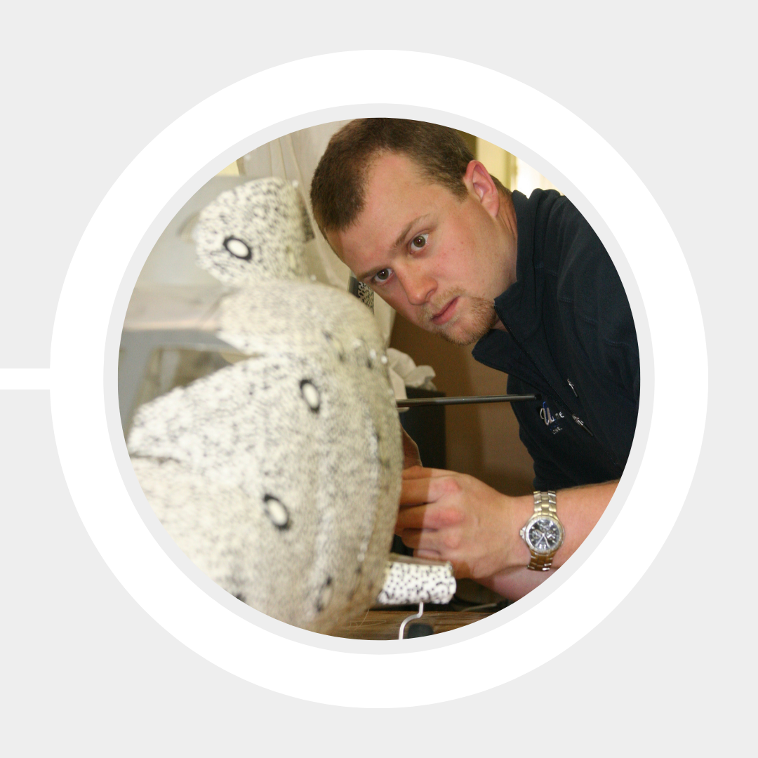 A student examines a lab-scale model up close