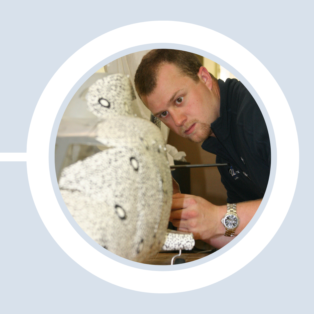 A student examines a lab-scale model up close.