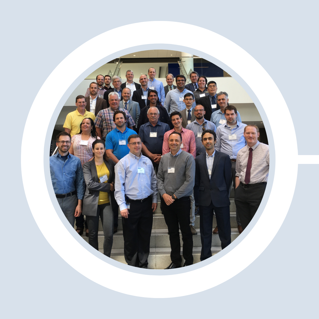 Engineers gather on a staircase to celebrate meeting together.