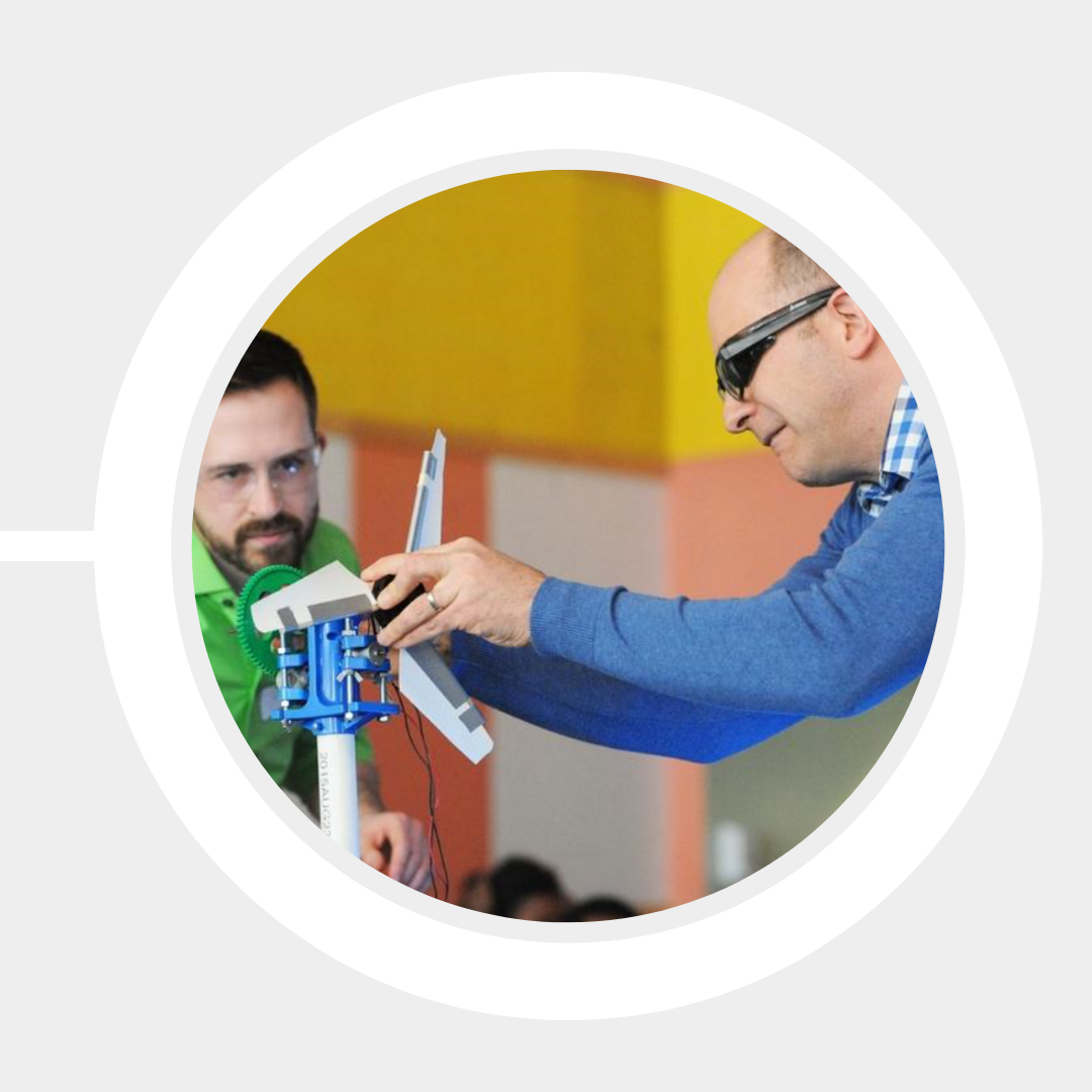 Profs. David Willis and Christopher Hansen demonstrate a miniature turbine setup.