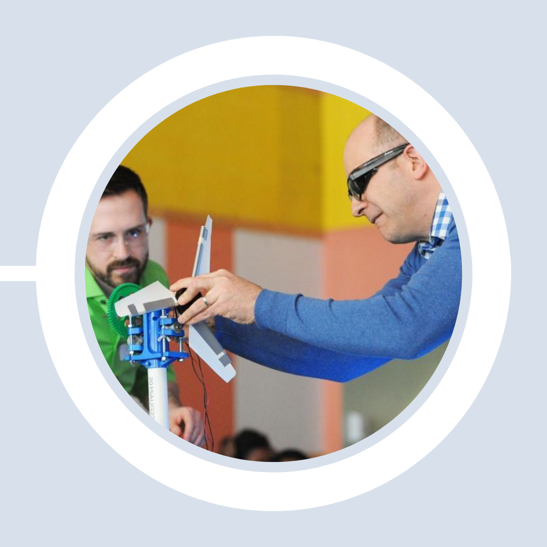 Profs. David Willis and Christopher Hansen demonstrate a miniature turbine setup.