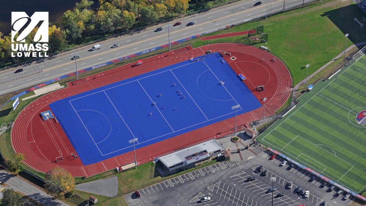 Zoom background displaying a bird's eye view of UMass Lowell's Wicked Blue field with UML logo in corner.