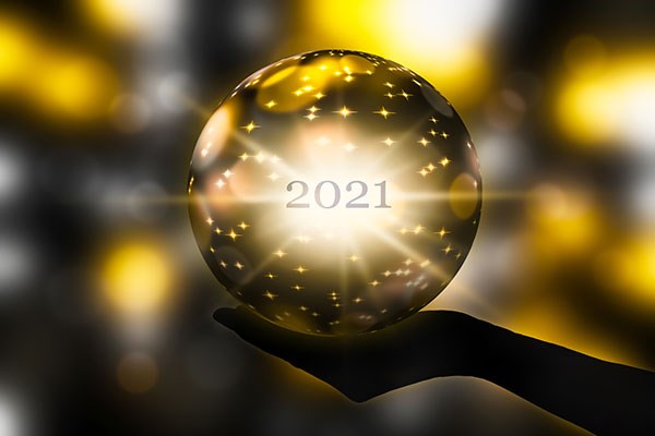Hand holding 2021 crystal ball