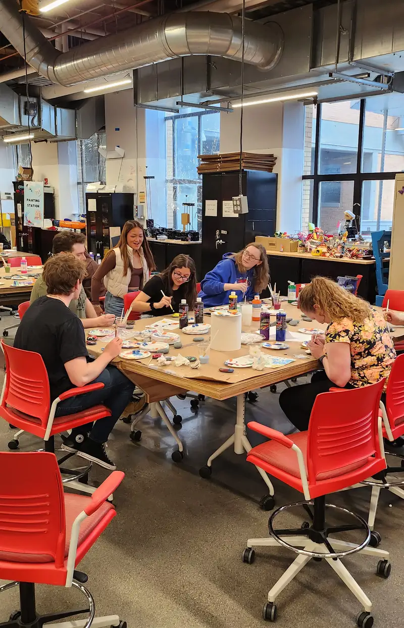 Six guests painting rocks during a Spring Makernight at the Lin Makerspace.