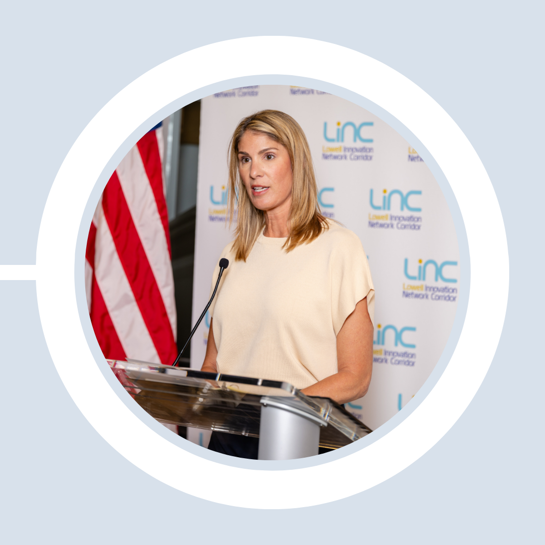 Congresswoman Lori Trahan gives remarks at the podium, welcoming Weston & Sampson to 201 Cabot St.