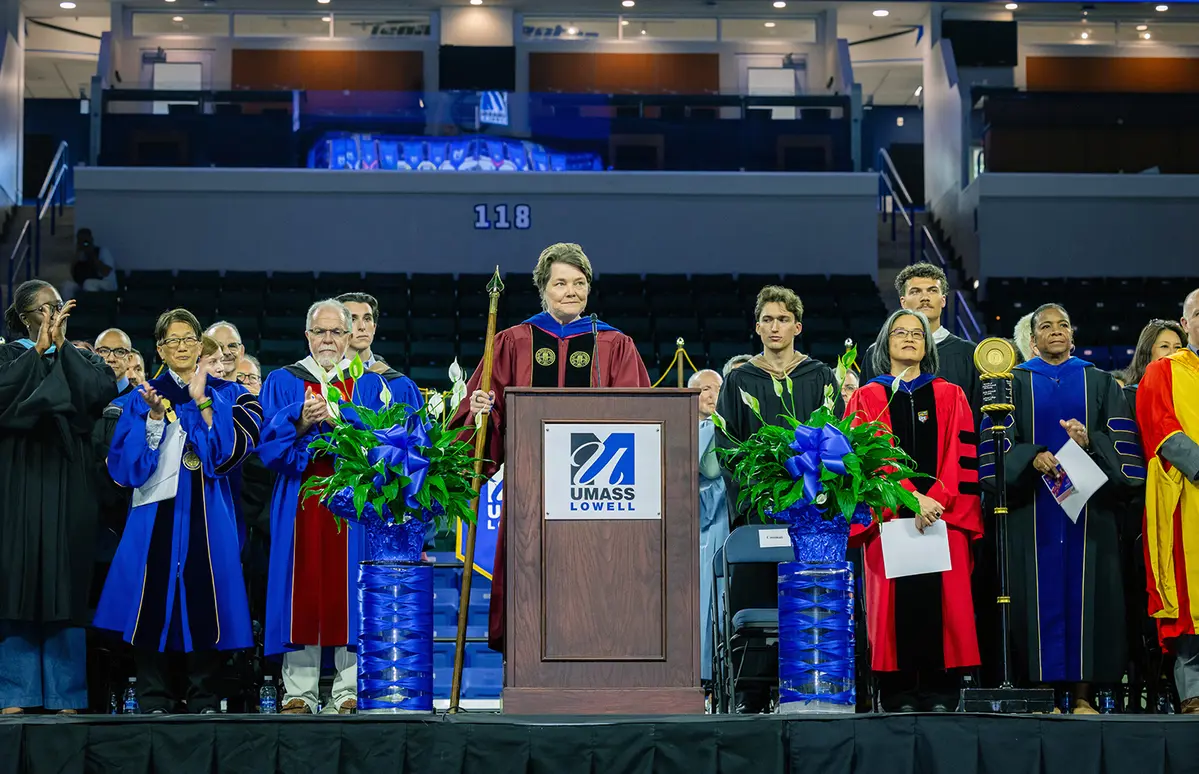 The Provost opens Convocation ceremonies on stage with faculty and staff.