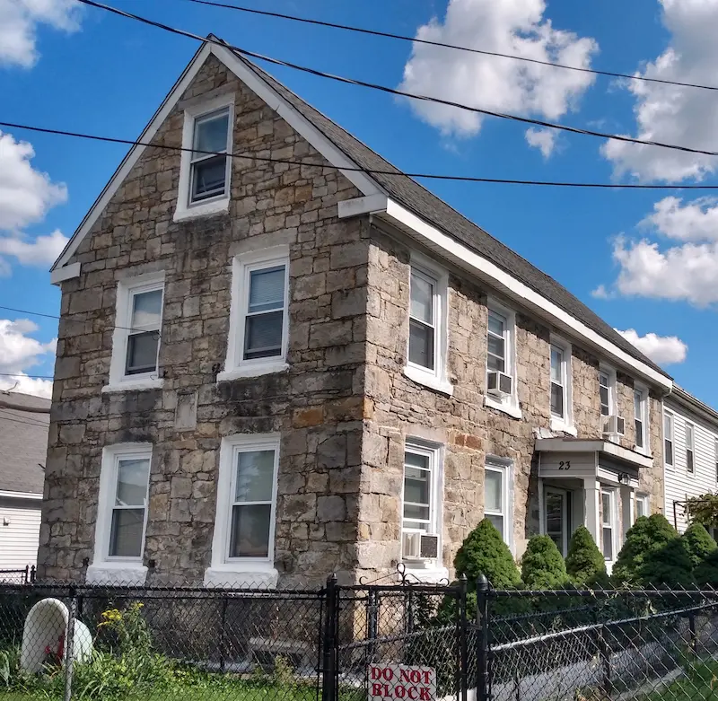 Gabled two-story stone house in the Federal/Georgian style.