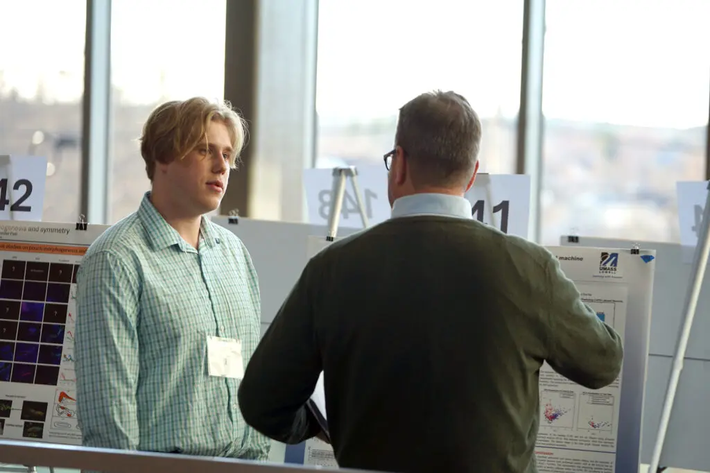 Student talking to a poster visitor