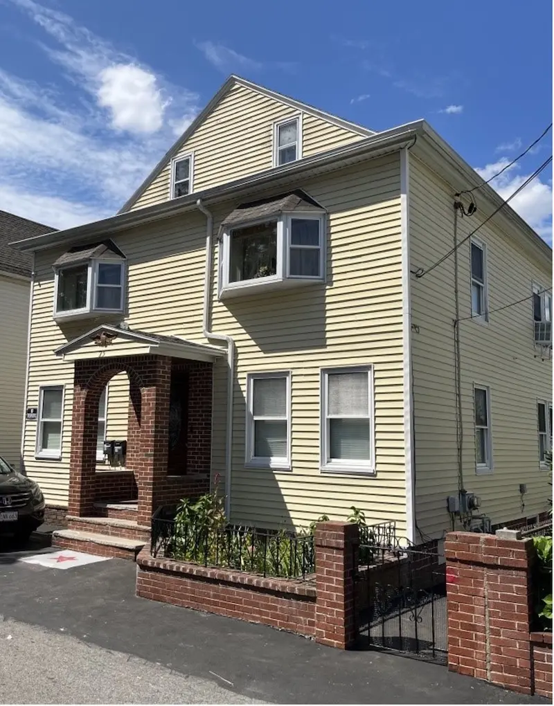 Exterior of three-story cottage.