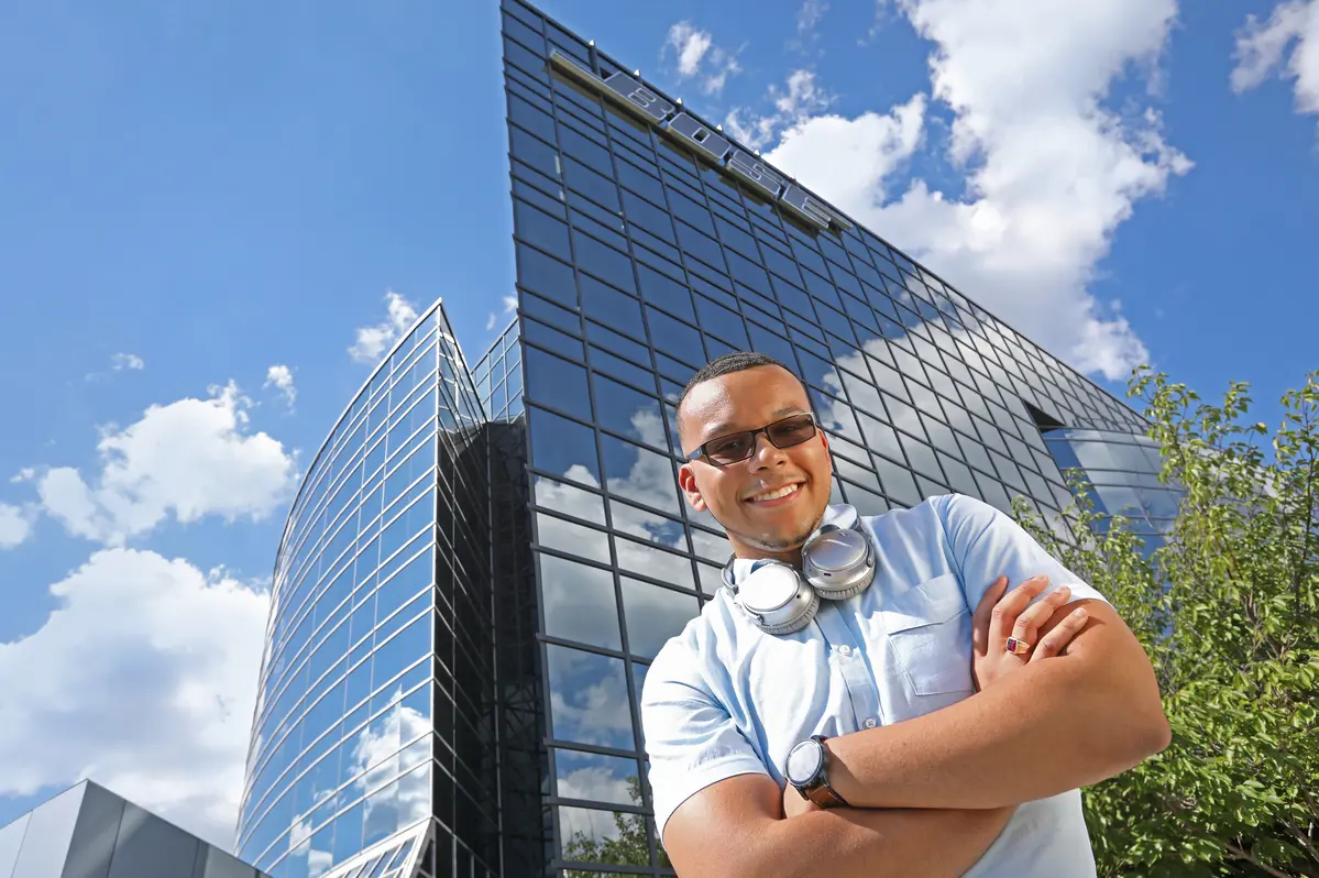 UMass Lowell co-op student stands in front of Bose headquarters