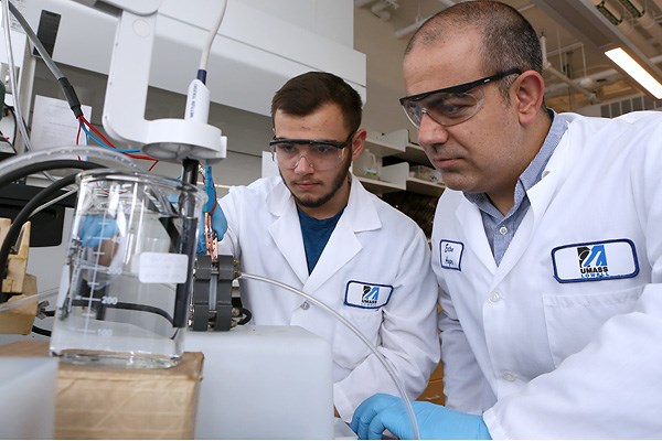 Asst. Prof. Ertan Agar and student Joseph Egitto carry out an experiment 